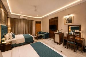 a hotel room with a bed and a desk at Prime Stay Bosan Hotel Multan in Multan