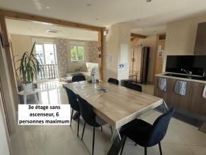 a kitchen with a table and chairs in a room at Appartements centre ville Colmar 4 familles in Colmar