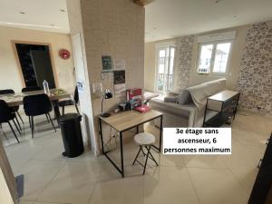 a living room with a couch and a table at Appartements centre ville Colmar 4 familles in Colmar