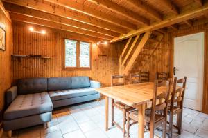 a living room with a table and a couch at Domaine Guillaume Chalet 6p classic in Auquainville