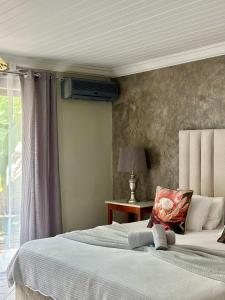 a bedroom with two beds and a window at Guesthouse 52 in Groblersdal +92 photos