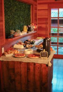 a buffet with many different types of food on a table at Hotel Cabanas Glamour in Gramado