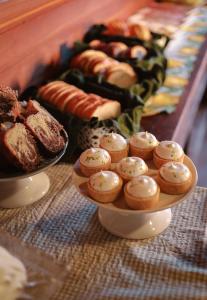 a plate of muffins and other pastries on a table at Hotel Cabanas Glamour in Gramado