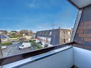 a view from a window of a building with a car at Charmant Studio Cabine 4 Pers, Balcons, Parking Privé, à 300m de la Plage de Merville-Franceville - FR-1-465-37 in Merville-Franceville-Plage