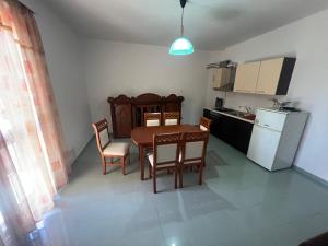 a kitchen with a table and chairs in a room at Vila Vollga in Durrës