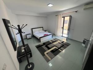 a room with a bed and a sign on the floor at Vila Vollga in Durrës