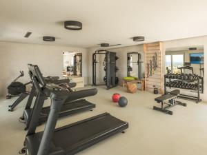 a gym with treadmills and weights in a room at Ovea Paros in Naousa
