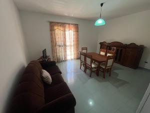 a living room with a couch and a table at Vila Vollga in Durrës