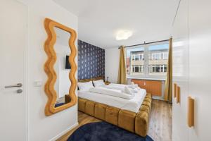 a bedroom with a bed with a mirror on the wall at Arbio I Cube Studios & Apartments St Pauli in Hamburg