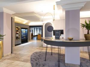 a kitchen with a island in the middle of a room at Mercure Mainz City Center in Mainz