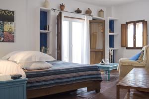 a bedroom with a bed and a couch and a table at Hotel Los Castaños in Cartajima