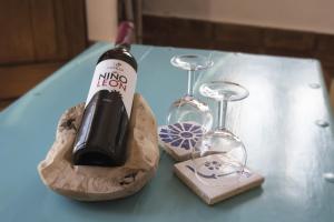 a bottle of wine and two wine glasses on a table at Hotel Los Castaños in Cartajima +34 photos