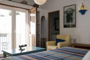a bedroom with a bed and a table and a chair at Hotel Los Castaños in Cartajima
