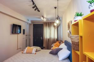 a bedroom with two beds and a yellow shelf at Cozy Twins - Terra in Kavála