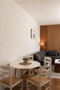 a living room with a table and chairs and a couch at Apartments Katana in Ulcinj