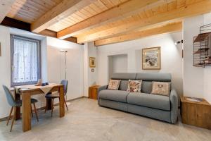 a living room with a couch and a table at Maison Jaccod Apartments in Morgex