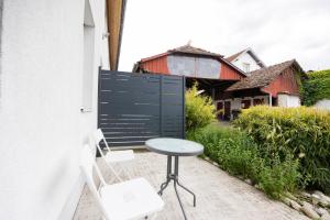 a table and chairs on a patio with a house at L'évasion - duplex in Zillisheim