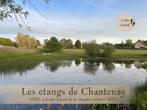 a sign that reads less charms de chaminery next to a lake at Chambre d'hôtes - demeure historique in Chantenay-Saint-Imbert +9 photos