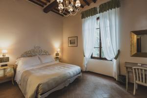 a bedroom with a bed and a large window at Hotel Villa Il Patriarca in Chiusi +176 photos