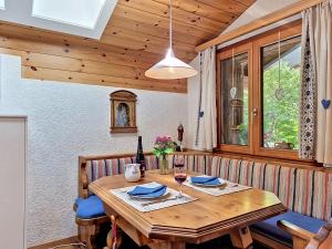 a wooden table with a bottle of wine on it at Chalet Himmulriich by Interhome in Gasenried