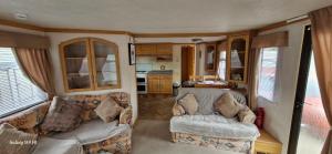 a living room with two couches and a kitchen in an rv at No 21 The Tummel in Forfar