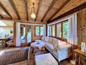 a living room with a couch and a table at Chalet Himmulriich by Interhome in Gasenried