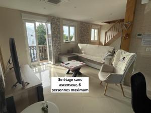 a living room with a couch and chairs and a tv at Appartements centre ville Colmar 4 familles in Colmar +50 photos
