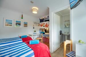 a small room with a bed and a desk at The Hides in Seahouses