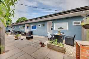 a patio in front of a blue house at The Hides in Seahouses