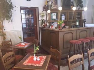 a restaurant with two tables and a bar at Pension Karina Schwerin in Schwerin