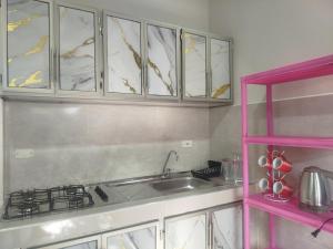 a kitchen with a sink and a counter top at Maxi&Mia Cabañas in Coveñitas