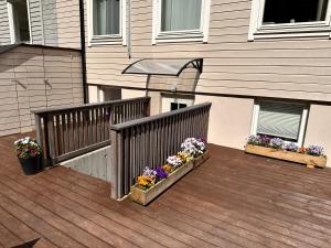 a balcony with two flower boxes on a house at Free parking Apartment is located on a semi basement floor, with a warm floor in Ålesund
