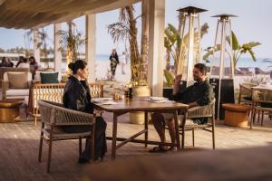 a man and woman sitting at a table in a restaurant at Stayr Somabay - Bay Life Home Rentals in Hurghada +231 photos