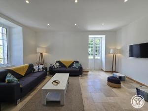 a living room with a couch and a table at Chadalou in Savignac-les-Églises