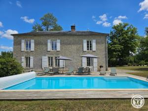 a house with a swimming pool in front of it at Chadalou in Savignac-les-Églises