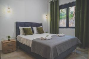 a bedroom with a large bed with towels on it at Vikanto Stay in Ulcinj