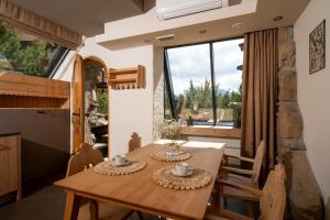 a kitchen and dining room with a table and chairs at Villa Miodula in Kościelisko +65 photos