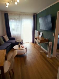 a living room with a couch and a table at Ferienwohnung Luitpold 1 in Memmingen