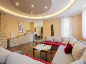 a living room with a couch and a table at Apartment Beige by Interhome in Balatonszemes