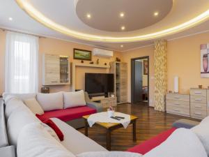 a living room with a couch and a tv at Apartment Beige by Interhome in Balatonszemes