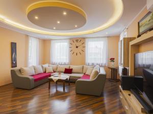 a living room with a couch and a clock on the ceiling at Apartment Beige by Interhome in Balatonszemes +19 photos