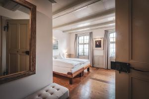 a bedroom with a bed and a mirror on the wall at Hotel Kreuz in Dürrenroth