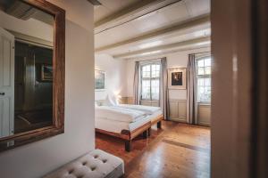 a bedroom with a bed and a mirror on the wall at Hotel Kreuz in Dürrenroth