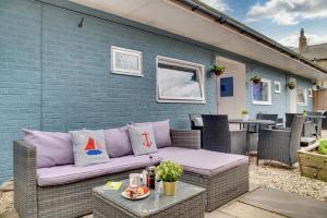 a wicker couch sitting on a patio at The Hides in Seahouses +13 photos