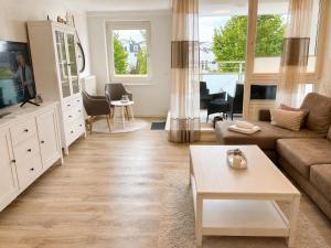 a living room with a couch and a tv at ZingstUrlauber in Zingst