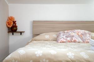 a bed with two pillows on top of it at La Mansarda di Terelle in Terelle