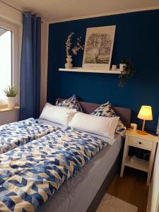 a bed in a room with a blue wall at Ferienwohnung Luitpold 1 in Memmingen