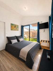 a bedroom with a large bed and a window at Le Studio, proche du puy in Saint-Pierre-Montlimart