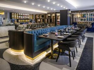 a dining room with a long table and chairs at Mövenpick Hotel Hobart in Hobart