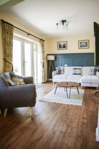 a living room with two couches and a coffee table at Ger Yr Afon in Saint Harmon +39 photos